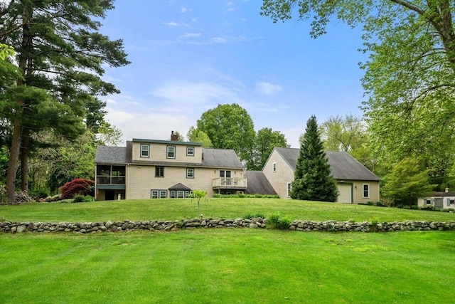 64 E Main St, Middleboro, MA 02346 - back of house featuring a lawn, a chimney, a sunroom, and a garage