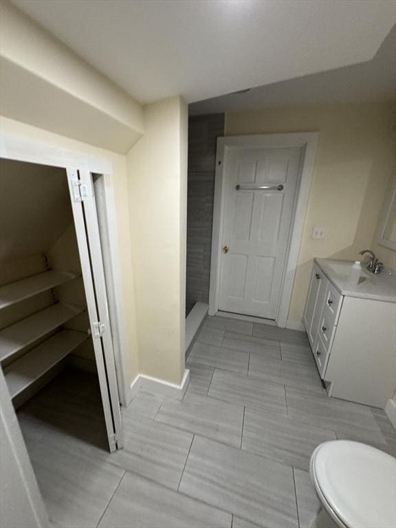 589-591 Washington St, Brookline, MA 02446 - full bath featuring a walk in shower, vanity, baseboards, and toilet