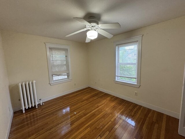 589-591 Washington St, Brookline, MA 02446 - spare room featuring radiator heating unit, hardwood / wood-style flooring, baseboards, and ceiling fan