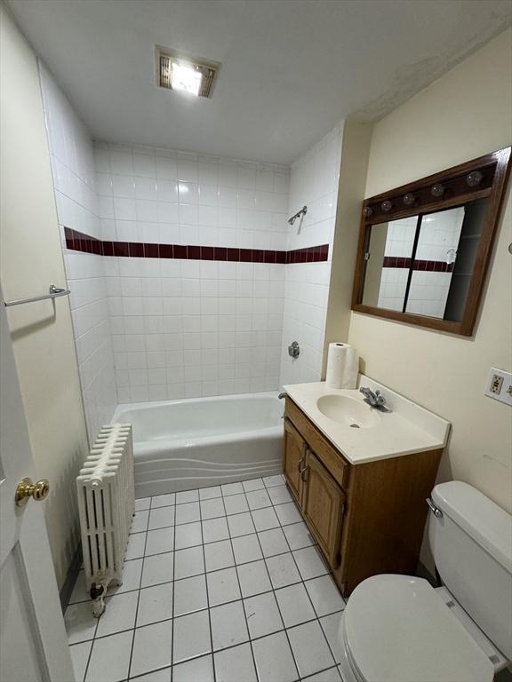 589-591 Washington St, Brookline, MA 02446 - full bath with radiator, tile patterned floors, toilet, and shower / washtub combination