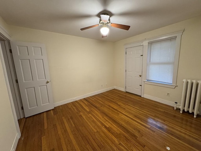 589-591 Washington St, Brookline, MA 02446 - empty room with radiator heating unit, wood-type flooring, a ceiling fan, and baseboards
