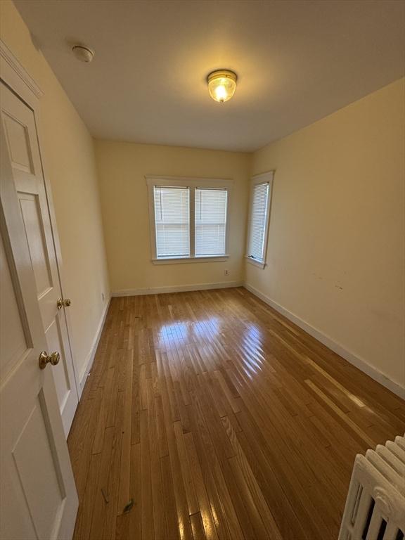 589-591 Washington St, Brookline, MA 02446 - unfurnished room with hardwood / wood-style flooring, baseboards, and a smoke detector
