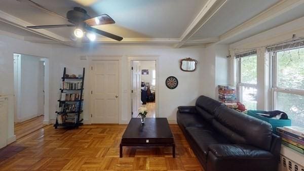589-591 Washington St, Brookline, MA 02446 - living room featuring coffered ceiling, ceiling fan, and beam ceiling
