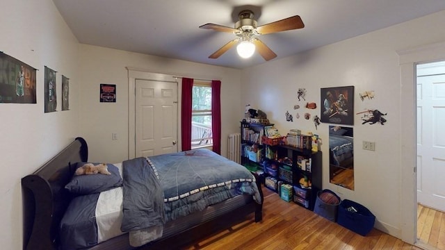 589-591 Washington St, Brookline, MA 02446 - bedroom with wood finished floors, a ceiling fan, and radiator heating unit