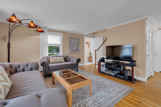 living room featuring hardwood / wood-style floors and crown molding