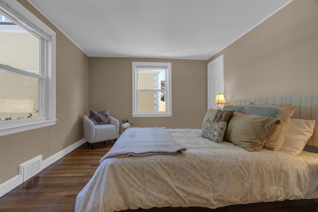 bedroom with dark hardwood / wood-style flooring