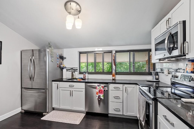 7 Longwood Dr Unit 212, Andover, MA 01810 - kitchen with appliances with stainless steel finishes, a sink, decorative backsplash, dark wood-style flooring, and vaulted ceiling