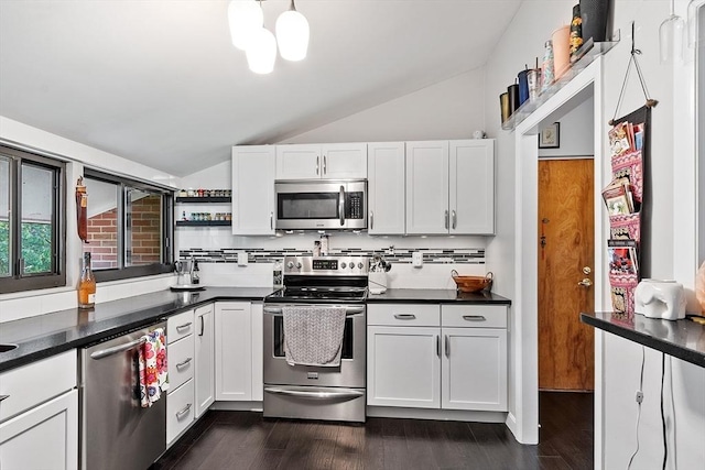 7 Longwood Dr Unit 212, Andover, MA 01810 - kitchen with stainless steel appliances, lofted ceiling, white cabinetry, and dark countertops