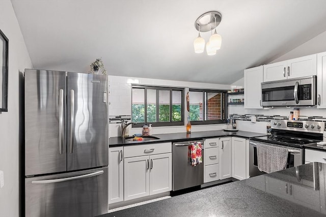 7 Longwood Dr Unit 212, Andover, MA 01810 - kitchen featuring stainless steel appliances, a sink, lofted ceiling, white cabinets, and dark stone countertops