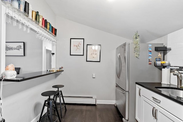 7 Longwood Dr Unit 212, Andover, MA 01810 - kitchen featuring a sink, dark wood-style floors, vaulted ceiling, white cabinets, and a breakfast bar area