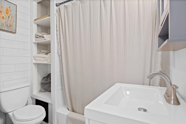 full bathroom featuring sink, toilet, and shower / tub combo