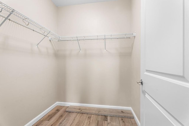 spacious closet with wood finished floors