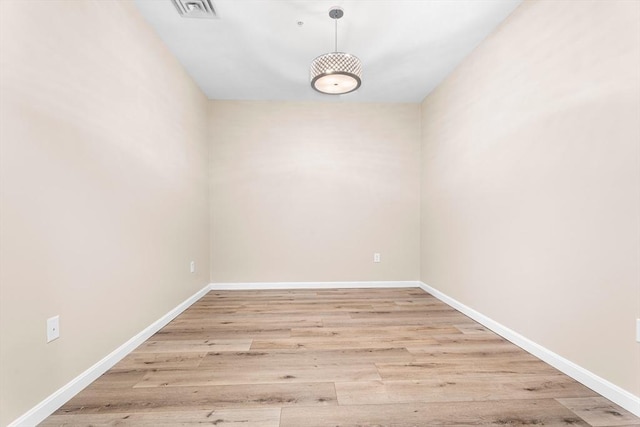 empty room featuring wood finished floors and baseboards