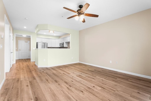 unfurnished living room with baseboards, light wood-style flooring, a ceiling fan, and recessed lighting