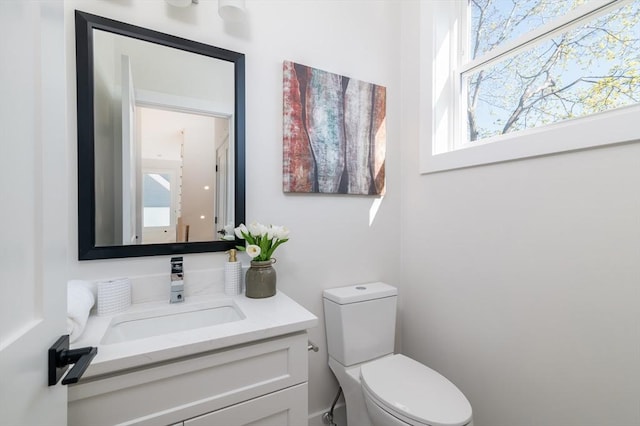 bathroom with toilet and vanity
