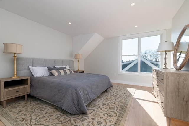 bedroom featuring multiple windows, recessed lighting, light wood-style floors, and baseboards