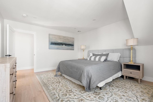 bedroom featuring light wood-type flooring and baseboards