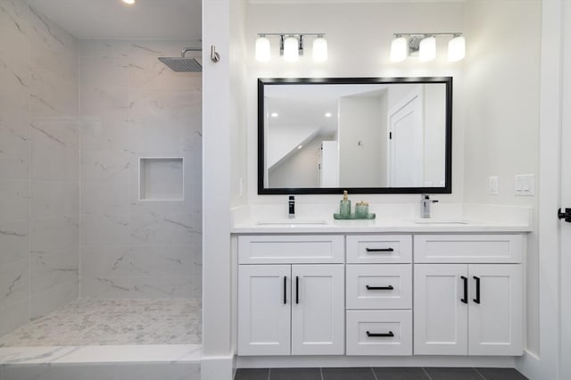 full bath with tiled shower and double vanity