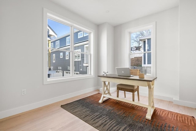 home office with wood finished floors and baseboards