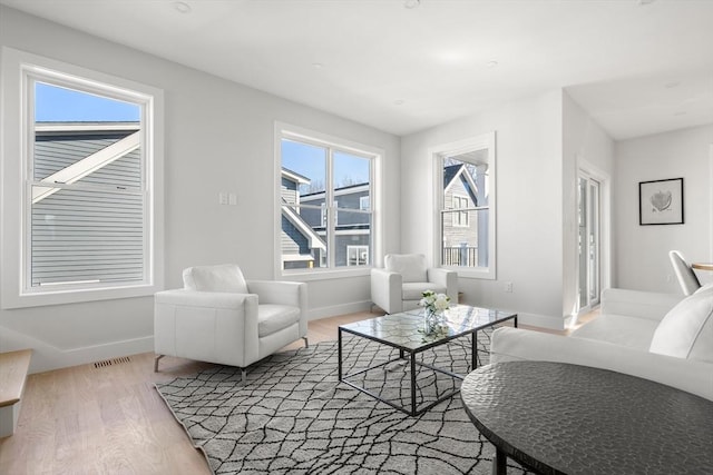 living area featuring wood finished floors and baseboards