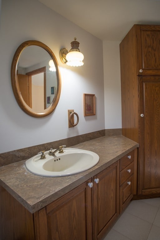 bathroom with tile floors and vanity