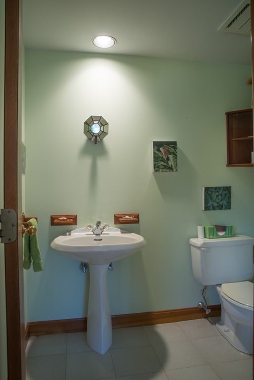 bathroom with tile floors and toilet