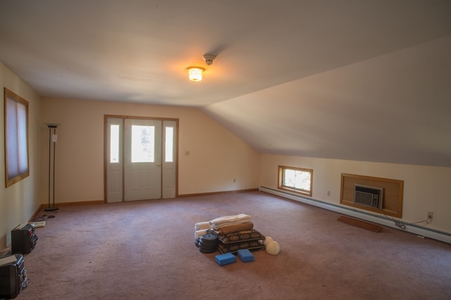 additional living space with light carpet, a wall mounted AC, vaulted ceiling, and a wealth of natural light