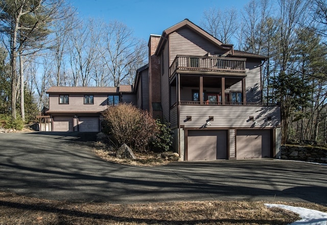 view of front property featuring a balcony and a garage