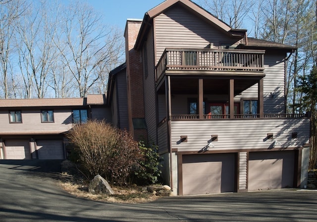 view of front facade with a balcony and a garage