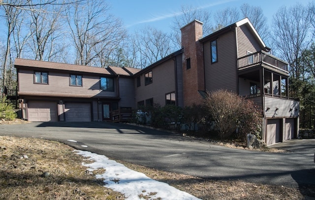 view of front facade featuring a balcony and a garage