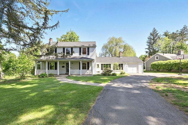 2 Silverwood Ter, South Hadley, MA 01075 - view of front of house with a porch, driveway, an attached garage, a chimney, and a front lawn
