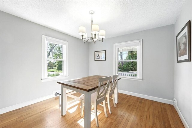 2 Silverwood Ter, South Hadley, MA 01075 - dining room featuring a chandelier, light wood-style flooring, baseboards, and a textured ceiling