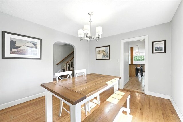 2 Silverwood Ter, South Hadley, MA 01075 - dining room featuring arched walkways, baseboards, a chandelier, and light wood finished floors