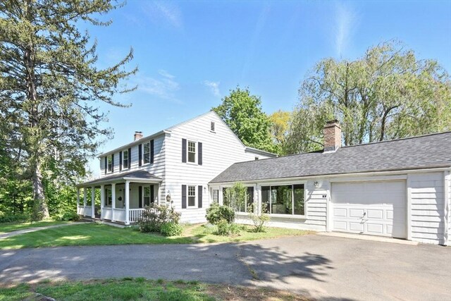2 Silverwood Ter, South Hadley, MA 01075 - colonial inspired home featuring a chimney, a garage, asphalt driveway, covered porch, and a front yard