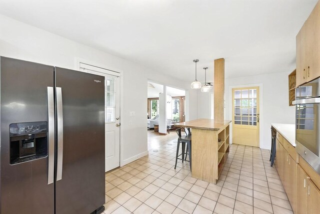 2 Silverwood Ter, South Hadley, MA 01075 - kitchen featuring stainless steel appliances, light tile patterned floors, open shelves, light countertops, and a kitchen bar