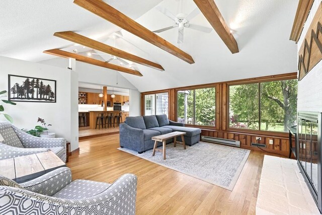 2 Silverwood Ter, South Hadley, MA 01075 - living room featuring baseboard heating, wood finished floors, ceiling fan, and a fireplace