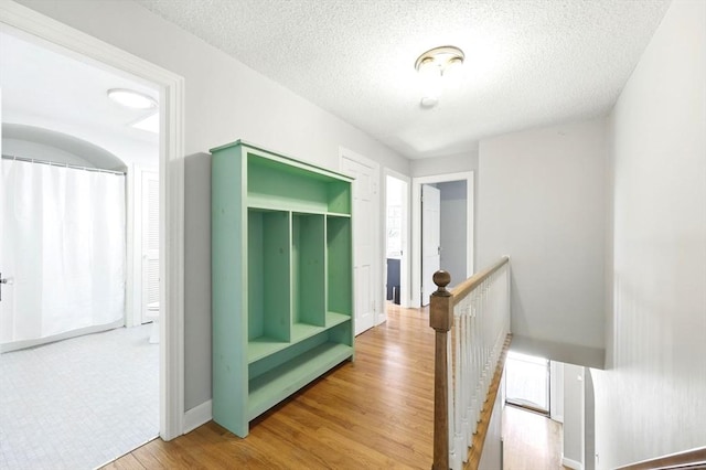 2 Silverwood Ter, South Hadley, MA 01075 - hallway with an upstairs landing, wood finished floors, and a textured ceiling