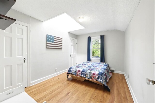 2 Silverwood Ter, South Hadley, MA 01075 - bedroom with wood finished floors, baseboards, vaulted ceiling, and a textured ceiling