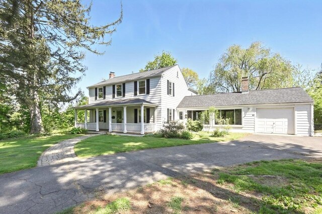 2 Silverwood Ter, South Hadley, MA 01075 - view of front of property featuring a chimney, asphalt driveway, covered porch, and a garage