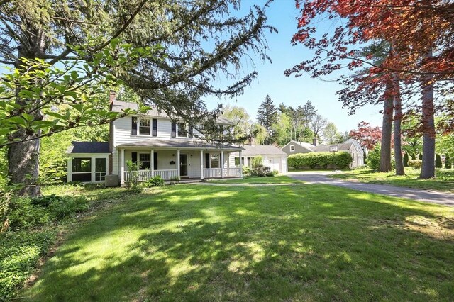 2 Silverwood Ter, South Hadley, MA 01075 - traditional home featuring covered porch, a chimney, a front lawn, and driveway