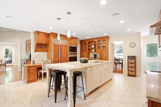 kitchen featuring a sink, recessed lighting, glass insert cabinets, and stainless steel appliances