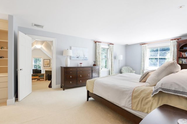 bedroom with visible vents and light carpet