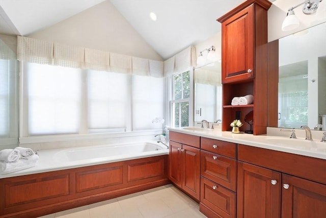 bathroom with a sink, lofted ceiling, a bath, and double vanity