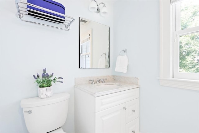 bathroom featuring toilet and vanity