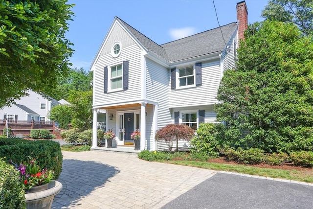 view of front of property featuring covered porch and a chimney