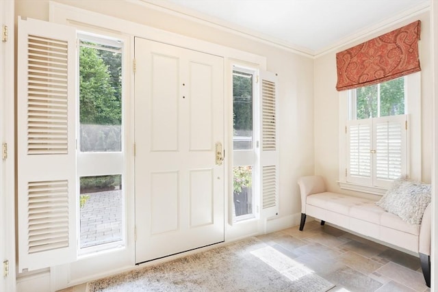 foyer entrance with crown molding and stone finish floor