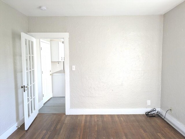 12-14 Essex St, Dover, NH 03820 - spare room featuring wood finished floors, baseboards, a smoke detector, french doors, and a textured wall