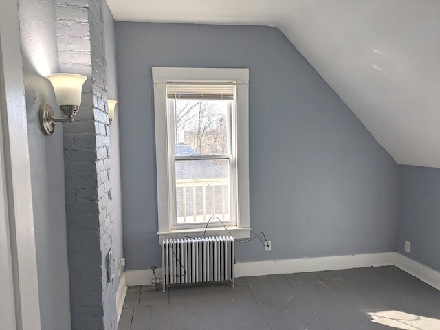 12-14 Essex St, Dover, NH 03820 - bonus room with radiator, vaulted ceiling, wood finished floors, and baseboards