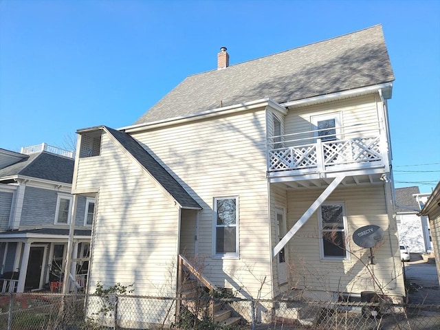 12-14 Essex St, Dover, NH 03820 - rear view of property featuring a balcony, a chimney, and roof with shingles