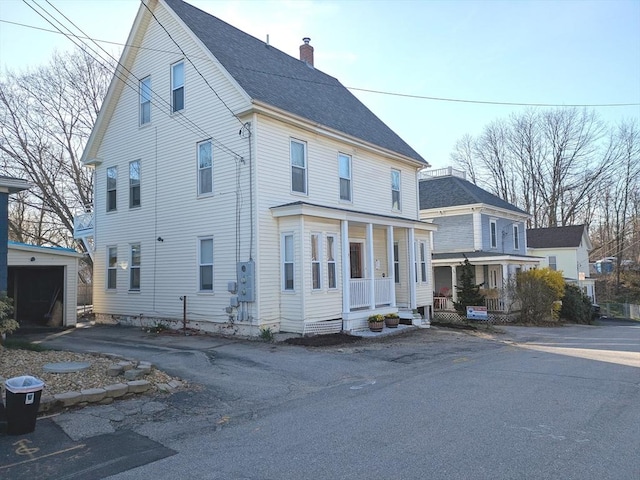 12-14 Essex St, Dover, NH 03820 - view of front of house featuring covered porch, a chimney, and a shingled roof